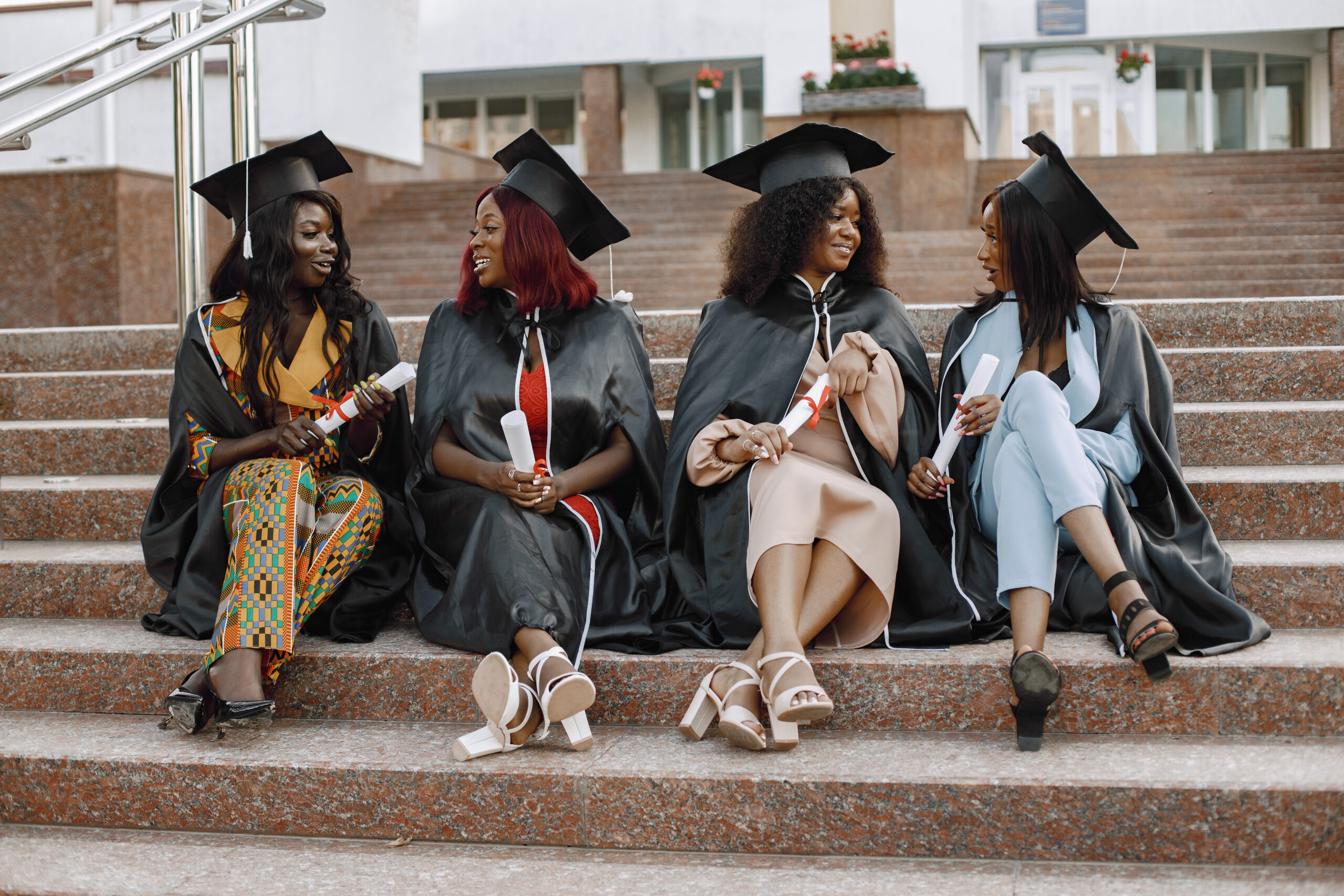 Graduating students in gowns on campus