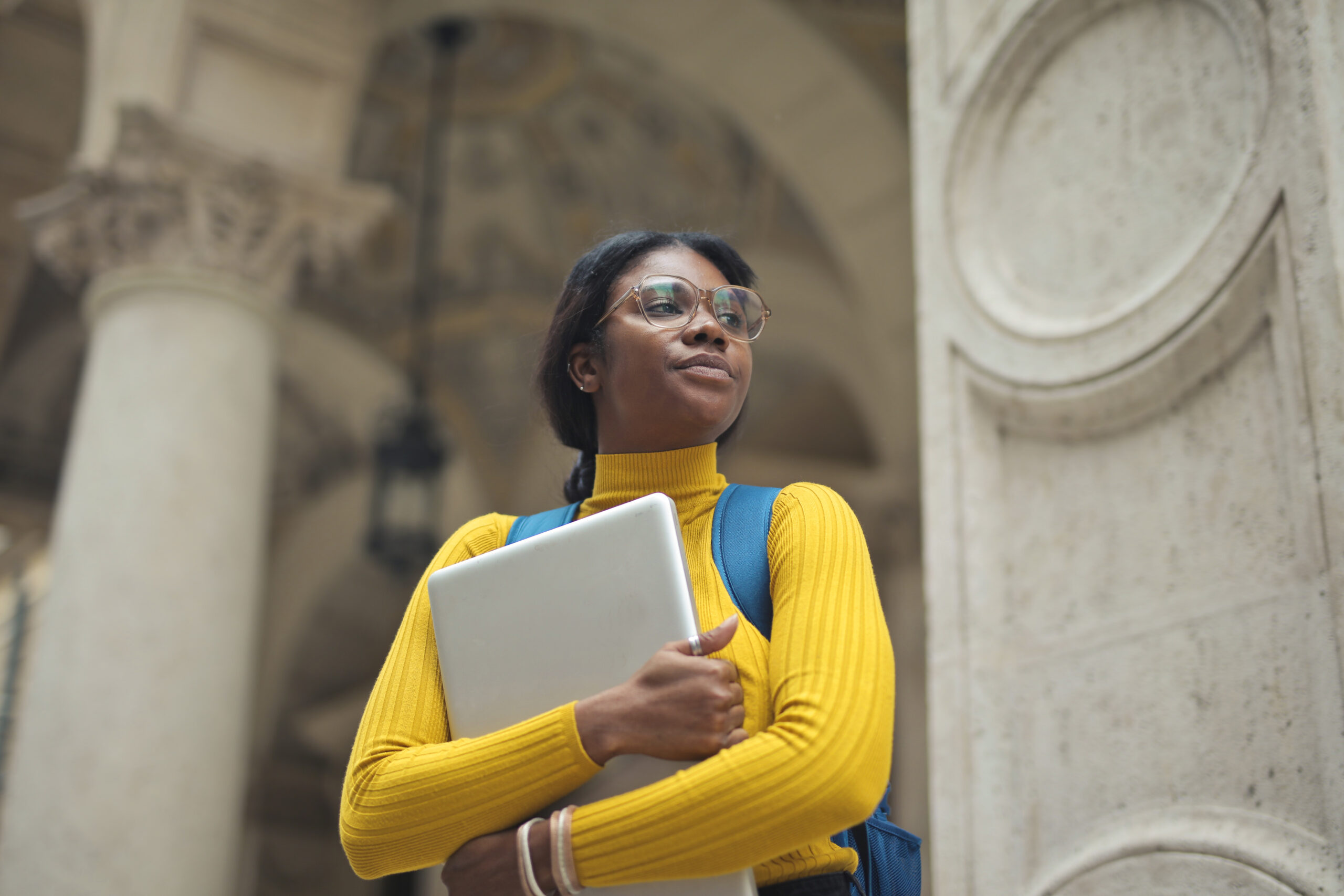 Student studying outdoors with a laptop